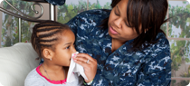 mother taking care of her daughter who is sick