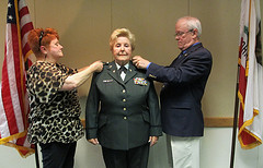 Rep McNerney frocks newly promoted Brigadier General Lucie Titus with the help of her daughter, Chrissy Titus.