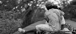 A Guatemalan migrant couple embraces on top of a northbound freight train while traveling through the Mexican state of Chiapas. June 2009.