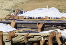 Syrian refugees and local residents carry the bodies of Syrian refugees, Emara al-Zoabi, 7 months old, Moath al-Rawashdeh, 30, and Ahmed al-Natoor, 62, during a funeral service in Ramtha, near the Syrian border December 2, 2012. REUTERS/Muhammad Hamed