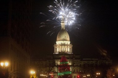 The 75-foot Christmas tree is lit during the annual Silver Bells festivities on Friday in Lansing. Events included a 5K, parade, Christmas tree lighting, fireworks, and Radio Disney concert.(Abbey Oldham | MLive.com)