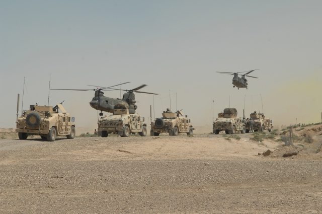 CH-47 Chinook helicopters land outside the village.