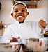 boy cooking in chefs uniform