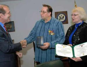 Congressman Scott Garrett (left) congratulates Ken Maruska, joined by his wife, Lois, after presenting Maruska with medals earned during his service in Vietnam. Maruska is holding a Purple Heart.