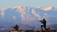 Metal silhouettes of soldiers dot the landscape overlooking the snow-covered Mount Hermon in the Golan Heights in January. (photo credit: Shay Levy/Flash 90)