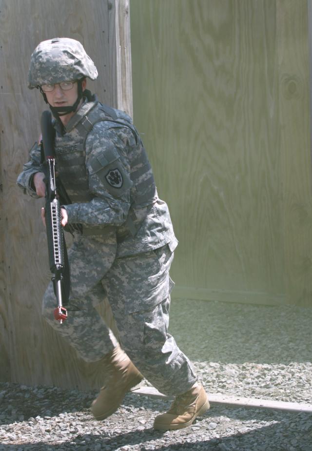 Sgt. Matthew Bledsoe, with Detachment 6, 3100th Strategic Intelligence Group, prepares to cross an alley as part of the Military Operations in Urban Terrain event of the Military Intelligence Readiness Command's 2011 Best Warrior competition, held at Fort Dix, N.J.  Competitors were required to lead a squad through buildings to find an injured Soldier and request medical evacuation.  Sgt. Bledsoe was named Best Warrior NCO.  (U.S. Army Reserve Photo by Maj. Annmarie Daneker/Released)