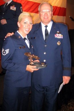 Krysta Carlson, with General Craig R. McKinley, receives the Pro Patria award honoring the office of Congressman Paulsen