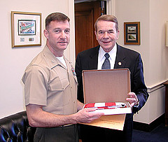 Rep. Kildee presents Flint native Colonel Wayne Hallem  with a U.S. flag flown over the Capitol.