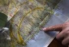 A staff member of a radiation check-up point points out a location of the tsunami-crippled nuclear plant on a map, on which a radiation gauge is placed, during a photo opportunity in an evacuation center in Fukushima, northern Japan, April 4, 2011. REUTERS/Kim Kyung-Hoon 