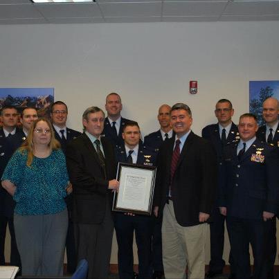 Photo: Presenting Lt. Col. Arnett with a copy of the Congressional Record honoring his service and retirement.