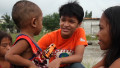 Filipino street kid helping others