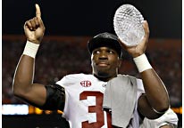 Image: Alabama's C.J. Mosley holds up The Coaches' Trophy after the BCS National Championship college football game against Notre Dame on Monday (© David J. Phillip/AP)