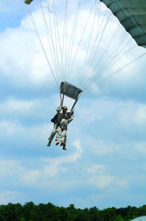 Brig. Gen. Gwen Bingham, Quartermaster School commandant, and her instructor, come in for a landing at Fort Pickett's Blackstone Army Airfield May 24.  Bingham visited with troops for the first time as the Quartermaster General and completed her first tandem jump.