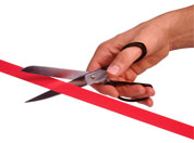 man cutting red tape