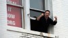 PHOTO: Larry Ward yells "Arm the teachers" as protestors rally past his office during the Emergency March on the NRA, organized by CREDO, in Washington, DC on Dec. 17, 2012.