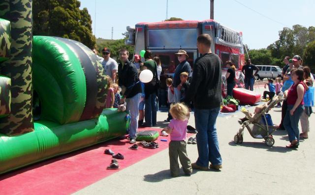 PRESIDIO OF MONTEREY, Calif. - Children and parents stand in line for the bouncy house and other kid-friendly activities during the Celebrating Military Children festival here April 24. The event offered information and activities for community children and their parents.