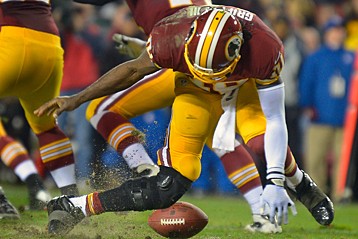 Robert Griffin III's knee buckles Sunday night (John McDonnell/The Washington Post)