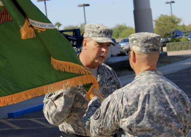 Brig. Gen. Scottie D. Carpenter, briefly talks to Lt. Col. Theodore Hawkins, the 387th Military Police Battalion commander, during the activation ceremony held in Scottsdale, Ariz., on Sept. 29. Carpenter is the 11th Military Police Brigade commander, which is subordinate brigade to the 200th Military Police Brigade.