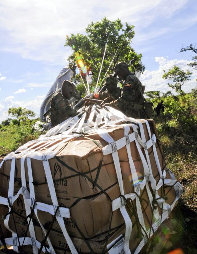 Uganda People's Defense Forces Soldiers work to free supplies dropped from a C-17 aircraft via a Low Cost Aerial Delivery system at Drop Zone White near Olilim, Uganda, April 18, 2011, during Atlas Drop 11.