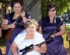 Awkward Family Photo of bridesmaids and bride holding guns.