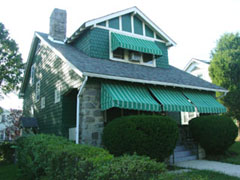 Simple shed-type awnings with acrylic or canvas coverings and free-hanging valances are appropriate for most historic residences featuring rectilinear openings. Photo: NPS files.