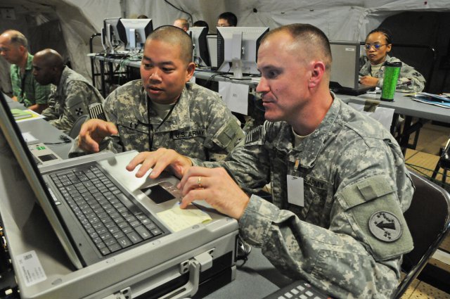 Chief Warrant Officer 2 Giac Ly discusses Eighth Army aviation processes and procedures with his U.S. Army Pacific Contingency Command Post counterpart, Chief Warrant Officer 2 Jeremy Drage, as they prepare to take part in exercise Ulchi Freedom Guardian at Camp Walker, South Korea, Aug. 18, 2012.