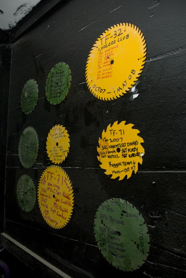 The Special Operations Task Force - South parachute rigger's wall of fame, as seen here Dec. 20, 2010, is for units whose teams have had at least 1 million pounds of supplies pushed out during their deployment rotation.  The wall represents the types of blades that cut skid plates and cushioning boards used in resupply bundles.  The current SOTF-South rigging crew is on tap to deliver more than 3 million pounds during their rotation at Kandahar Airfield, Afghanistan.