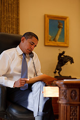 President Barack Obama reading at his desk.