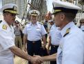 Commander, Carrier Strike Group 2 greets a Coast Guard officer aboard Barque Eagle