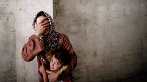 Woman clutches her daughter during air strike in Aleppo (Sept 2012)