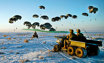 Soldiers wait as bundles of fuel are air delivered to Forward Operating Base Waza K'wah in Paktika province, Afghanistan, Jan. 30, 2011.