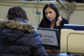 A FEMA Applicant Services Program Specialist speaks with a disaster survivor at a Disaster Recovery Center.