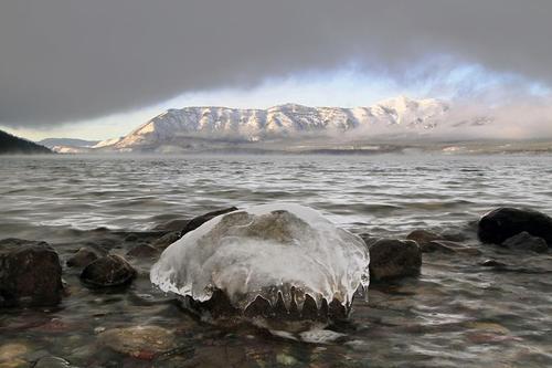 Lake McDonald in Glacier National Park hasn&#8217;t frozen over this winter, but this rock is giving it a good try. Photo: T. McCracken, National Park Service