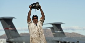Joe Gasak celebrates his pull of a C-130 Hercules starter after working two hours to get the part free.