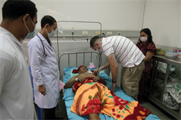 U.S. Navy Lt. Cmdr. Lawrence Decker, right, listens to a patient’s chest at the Preah Ket Melea Hospital, Phnom Penh, Jan. 25 during Cambodia Medical Exercise 13-1. Marine Corps and Royal Cambodian Armed Forces medical personnel worked together during subject-matter expert exchanges to increase medical capability, capacity and interoperability. Decker is the subject-matter expert in emergency medicine with 3rd Medical Battalion, Combat Logistics Regiment 35, 3rd Marine Logistics Group, III Marine Expeditionary Force. 