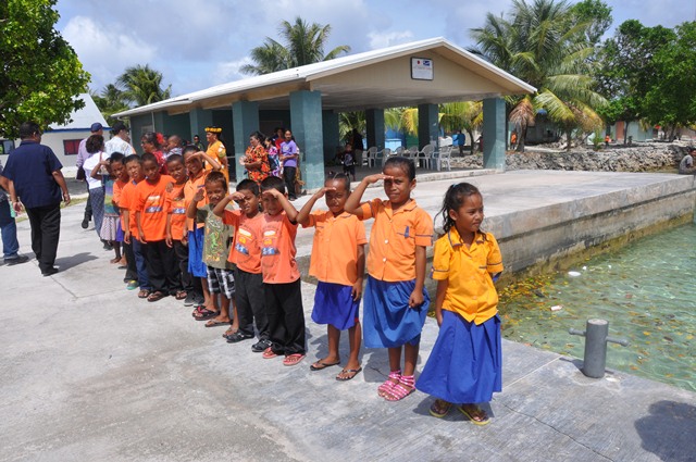 Ejit Elementary School students welcome Ambassador Armbruster, Minister Hilda Heine, and other members of their delegation to the dedication ceremony for their new classrooms (Credit: State Department).