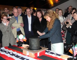 Public Affairs Officer Susan Cleary cuts the “Lincoln Top Hat” cake