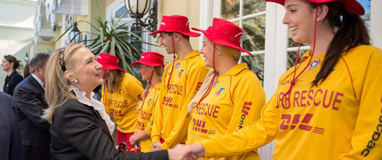 Secretary Clinton shakes hands with Australian Lifesavers in Perth