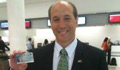 Ambassador Bleich holding up his U.S. Global Entry card