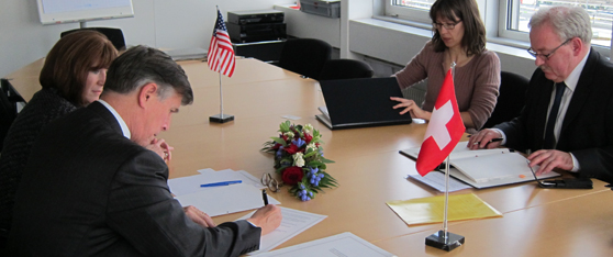 Ambassador Beyer discusses the agreement with Director Brechbühl (Photo courtesy of Martin Dale)