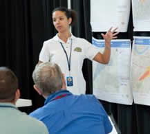 Female trainer presents to group during Amber Waves exercise