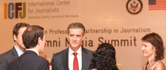 U.S. Ambassador Richard Olson greets American and Pakistani journalists at a media summit for alumni of the U.S.-Pakistan Professional Partnership in Journalism.