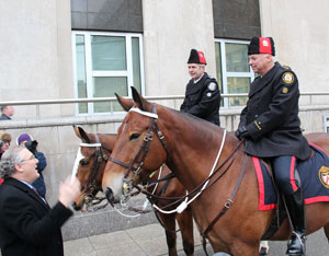 Consul General Jim Dickmeyer greets Honest Ed (background) and Tecumseh along with their riders, Sgt. Jim Patterson and Staff Insp. Bill Wardle, respectively. 