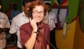 U.S. Consul General Jennifer McIntyre listens to a mock telephone automated message on AIDS counseling and awareness during her visit to the Red Ribbon Express train in Chennai on May 28,, 2012. (Photo by TANSACS)