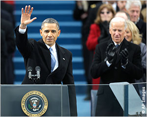 At the 57th Presidential Inauguration on the Capitol steps in Washington, President Obama waves after his inaugural address while Vice President Biden applauds (AP photo).