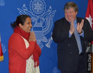 Ambassador Peter Bodde applauds 2012 CNN Hero of the Year Pushpa Basnet for her work with children whose parents are in prison 
