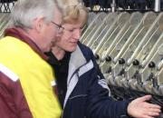 Kevin Lordan, USAID consultant, and Maria Ciolacu, Filatura Ungheni Director, analyze yarn quality. (PHOTO: USAID CEED II PROJECT)