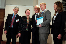 EERE officials present the Clean Energy Challenge award to a young entrepreneur.