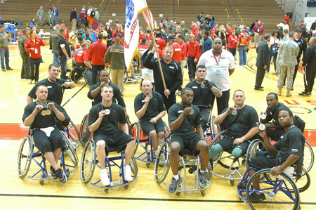 Members of the Army wheelchair basketball team display silver medals at Warrior Games.