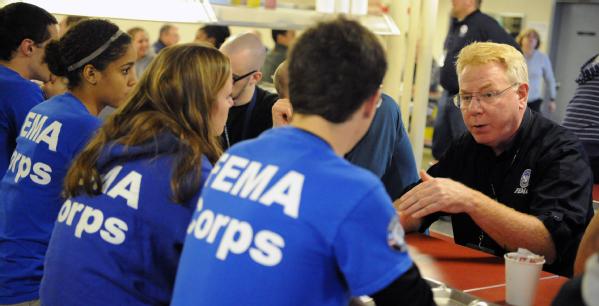 New York, N.Y., Dec. 1, 2012 -- Federal Coordinating Officer Michael Byrne, right, talks to FEMA Corps members aboard the Training Ship Empire State VI, docked on the East River at the foot of the Throgs Neck Bridge. The ship has provided accommodations for volunteers from FEMA Corps and Federal Surge groups who have come to assist in the recovery efforts for Hurricane Sandy.